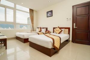 Ένα ή περισσότερα κρεβάτια σε δωμάτιο στο Sunview Beach Hotel Danang