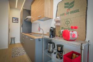 a small kitchen with a red appliance on a counter at BergamoCityCenter 04 in Bergamo