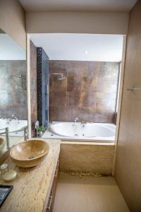 a bathroom with a large tub and a sink at Phuket Boutique Pool Villa-80 in Rawai Beach
