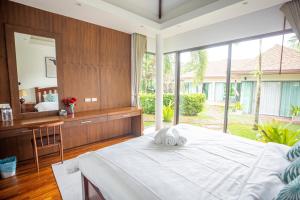 a bedroom with a large bed and a mirror at Phuket Boutique Pool Villa-80 in Rawai Beach +82 photos