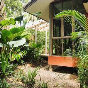 a greenhouse with a bench in a garden at Cocohut Garden 