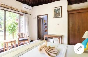 Postel nebo postele na pokoji v ubytování Ary House Ubud