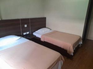 a room with two beds and a mirror at OYO 1011 First Hotel in Manila