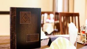 a book sitting on top of a table at Villa Dvor SUBOTICA in Subotica