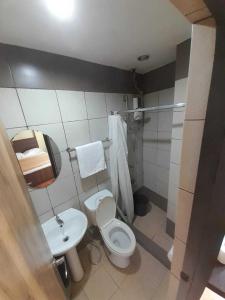 a bathroom with a toilet and a sink at OYO 1011 First Hotel in Manila