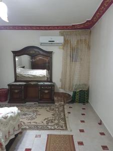 Schlafzimmer mit einem Bett und einem Wandspiegel in der Unterkunft شقة مفروشة in Kairo
