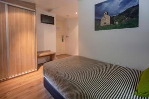 Llit o llits en una habitació de Hotel Del Pui