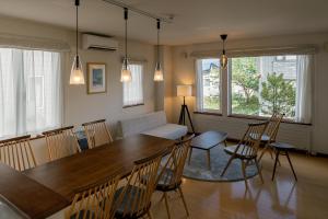 a living room with a dining room table and chairs at Casi 15 in Furano