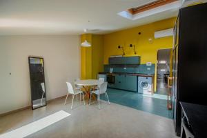 a kitchen with a table and chairs in a room at La Scivola Rooms in Acitrezza