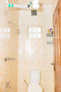 a bathroom with a toilet and a shower at Homely Escapes in Nanyuki