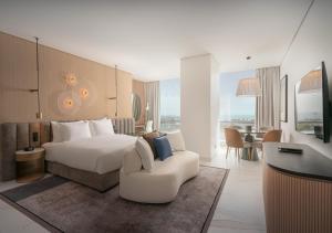 a hotel room with a bed and a chair at JOUDYAN Red Sea Mall Jeddah By ELAF in Jeddah