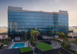 a large glass building with a pool in front of it at JOUDYAN Red Sea Mall Jeddah By ELAF in Jeddah