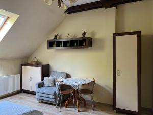a living room with a table and a chair at Apartament Orle Gniazdo in Reda