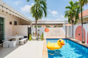 a pool with a rubber duck in the middle of a house at Winter Home Villa Huahin in Cha Am