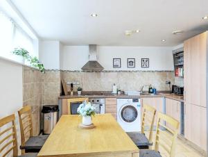 a kitchen with a table and a washing machine at Guest Rooms In City Centre Near Key Attractions in Liverpool