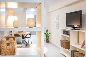 two views of a living room and a living room with a tv at Praxitelous 141 City Apartment in Piraeus