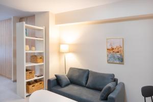 a living room with a couch and a book shelf at Praxitelous 141 City Apartment in Piraeus