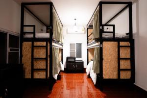 a room with three bunk beds in a room at ANOU HOSTEL in Pakse