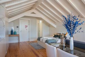 a bedroom with a bed and a table with blue flowers at Nautical Luxury Loft in Porto