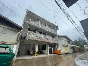 a building with a balcony on the side of it at Marion's Inn Bldg 2 Bantayan powered by Cocotel in Bantayan Island