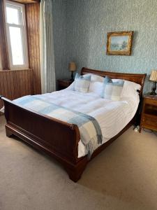 a bedroom with a large bed in a room at Conval House Bed And Breakfast in Dufftown