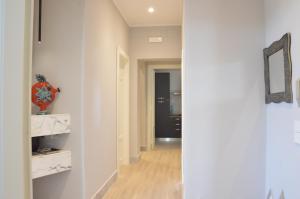 a hallway with white walls and a mirror at Via Roma in Reggio di Calabria