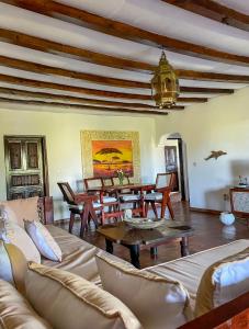 a living room with a couch and a table at Tembo village Watamu in Watamu +36 photos