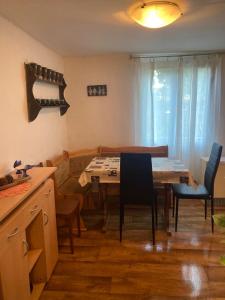 a kitchen and dining room with a table and chairs at Rekreační chata Hradištko in Hradišťko