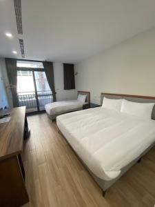 Postel nebo postele na pokoji v ubytování 浯島文旅WD Hotel