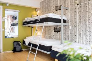 two bunk beds in a room with a mirror at Slottsskogens Hostel in Gothenburg