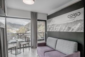 a living room with a couch and a table at Corso Living in Sölden