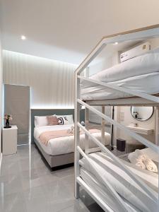 a bedroom with two bunk beds and a bed at Harmonic HuaHin Pool Villa-3BR, 3 Bath, 2 Kitchen in Hua Hin