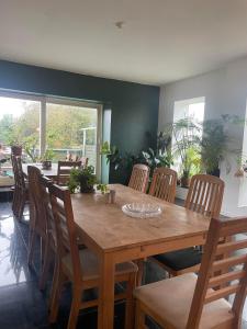 a dining room with a wooden table and chairs at B&B Fryden Ly in Horsens