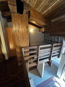 a room with two bunk beds and wooden ceilings at Chalet Edelweiss - Estella Hotel Collection in Sestriere