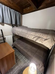 a room with two bunk beds and a table at Chalet Edelweiss - Estella Hotel Collection in Sestriere