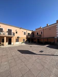 an empty parking lot with buildings in the background at Hotel Le Rose in Tivoli Terme