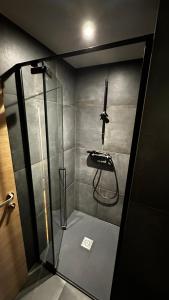een douche met een glazen wand in een kamer bij Chalet Le 36 Le Mont Dore 6pers in Le Mont-Dore