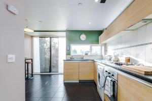a kitchen with a sink and a stove top oven at Tranquil 3 Bedroom Manchester Retreat With Parking in Manchester