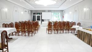 a conference room with tables and chairs and a screen at Restauracja Kargul noclegi in Łęczyca