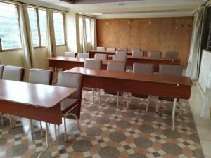 a conference room with tables and chairs and windows at TAITA LUXURY HOTELS LTD in Wundanyi