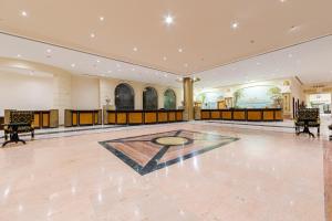 a large room with a dance floor with a painting on the wall at Siva Golden Bay Makadi in Hurghada