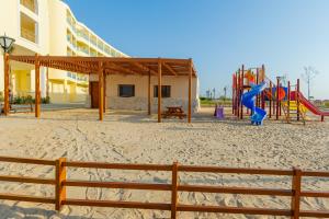 a playground on the beach next to a building at Siva Golden Bay Makadi in Hurghada
