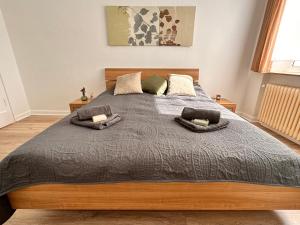 a bedroom with a large bed with two pillows at Modernes Appartement Nähe City in Dortmund