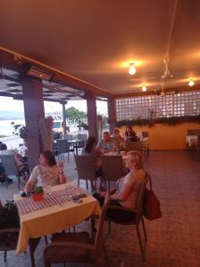 a group of people sitting at tables in a restaurant at Vinci brvnara Omladinac in Vinci