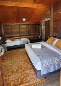 a bedroom with two beds and a rug at PULANG RESORT in Setiu