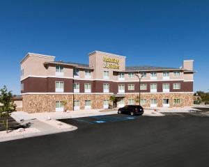 a hotel with a car parked in a parking lot at MainStay Suites Hobbs in Hobbs