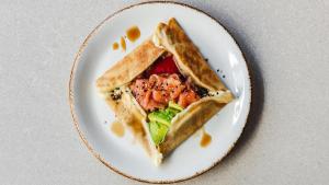 a sandwich on a plate on a table at Chic & Basic dot in Madrid