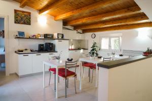 a kitchen with white counters and a table and chairs at Tana del Riccio in Ortona