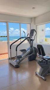 a gym with a treadmill and a view of the ocean at Luxury Apartment near airport in Negombo