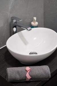 a white sink with a pink tie on a counter at Casa Silva Diamond in Pinhal Novo